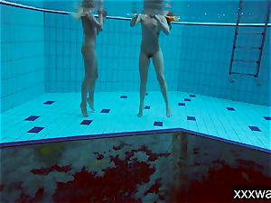 scorching Russian femmes swimming in the pool